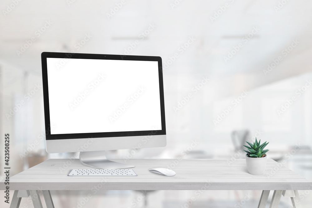 Poster computer display mockup on office desk. free space beside for promo text. clean desk with plant, key