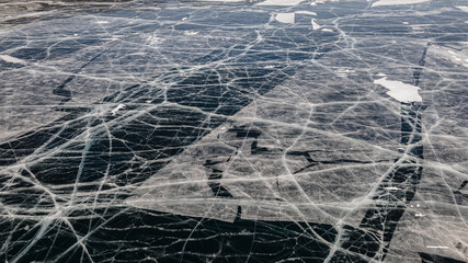 Deep Blue Cracked Ice. Top Aerial View. Frozen Texture of Baikal Lake in Russia