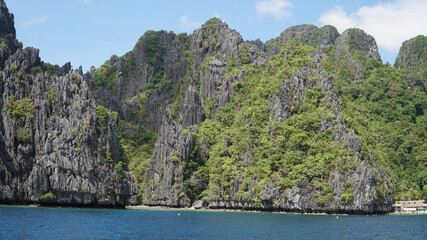 Green lush karst mountains rising out of the ocean on Palawan Island near El Nido, Philippines