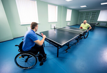 Adult disabled men in a wheelchair playing table tennis