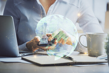Double exposure of social network sketch hologram and woman holding and using a mobile device.