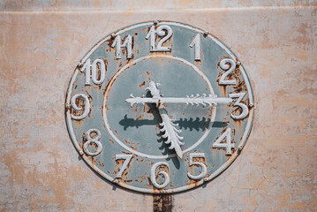 Retro and antique clock made on the wall of a building