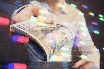 Double exposure of technology drawing hologram and us dollars bills and man hands. Data concept