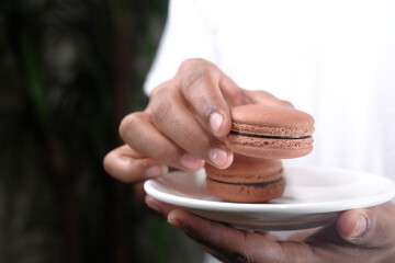  young man eating brownie on plate 