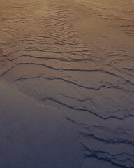 Obraz premium Elegant snow ripples on the surface of sea ice with warm and cold hues