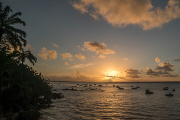 Fototapeta na wymiar Beach sunset with boats and palm tree