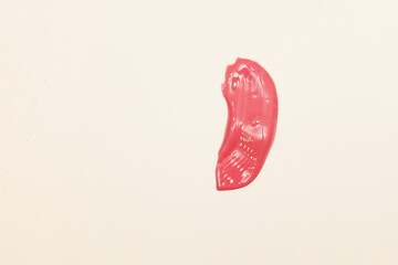 Smudged pink lipstick isolated on a white background