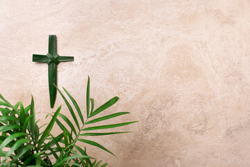 Palm Sunday concept. Cross made of palm and tropical leaves. Christian moveable feast to celebrate Jesus' triumphal entrance into Jerusalem - 423517256