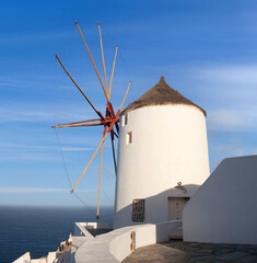 Old white traditional windmill in Oia village on Santorini Island, Cyclades, Greece