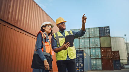 Multiethnic Female Industrial Engineer with Tablet and Black African American Male Supervisor in...