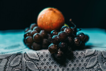 Night still life with grapes and apple