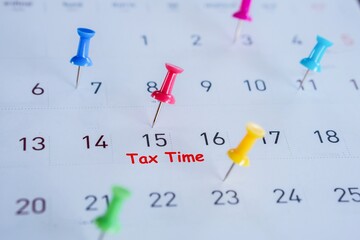 tax time concept with remind note and pin on date 15th on calendar, tax season concept