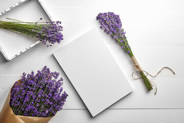 White canvas mockup and lavender flowers bouquet on white wooden table background, flat lay