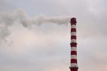 Smoking chimney of a factory or factory on the background of the sky