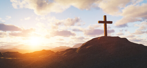 Cross on mountain peak at sunset christian religion