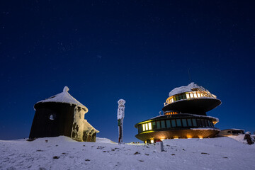 peak of Sniezka mountain during winter at night with stars sky on Poland and Czech border