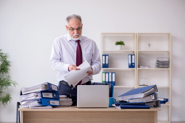 Aged male employee unhappy with excessive work