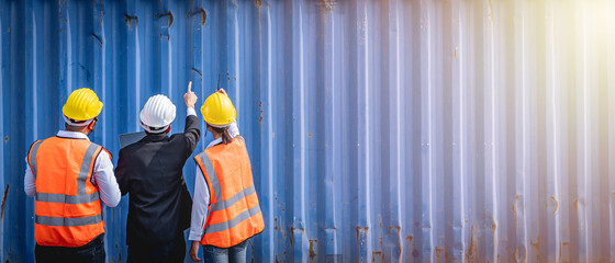 A manager and engineers inspecting the shipping container. Logistics and shipping. Professional...