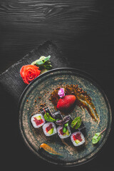 sushi roll in plate on wooden table background