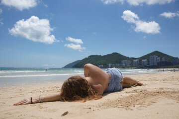 Beautiful Girl in a swimsuit on the beach. Tropical Landscape	