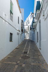 Fototapeta na wymiar Typical white street in Vejer de la Frontera. White towns of Andalusia in Cadiz, Spain