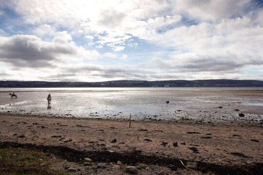 Rider and horse on the banks of the river Clyde