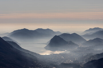 Foggy autumn mountains with a lake view on an arfternoon