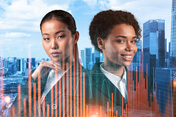 Two young attractive businesswoman in suits pondering about new venture capital and hi-tech start up and try to forecast risks and estimate prospective earning growth. Hologram chart on Singapore.