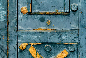 Fragment of old door with cracked paint