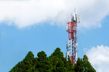 Communication transmitter tower with antenna on blue sky background