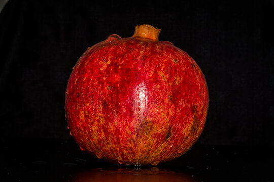 Pomegranate against a black background