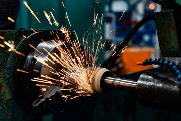 Grinding with sparks with the butt end of an abrasive wheel on a grinding machine.