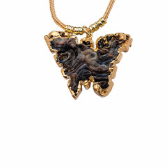 necklace with butterfly ornament in rustic stone bathed in gold