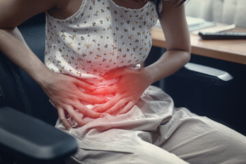 Obraz premium oung adult woman have stomach ill from period menstruation on day time.