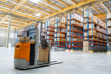 Interior view of a warehouse with racks, pallets, goods, forklifts