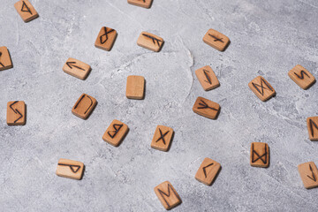 Scandinavian magic runes made of oak on concrete