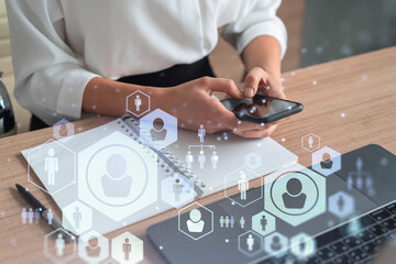 HR woman specialist in formal wear browsing social networks in the Internet in smart phone to find the best candidates to hire international team. Concept of success. Media hologram icons.