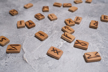 Scandinavian magic runes made of oak on concrete