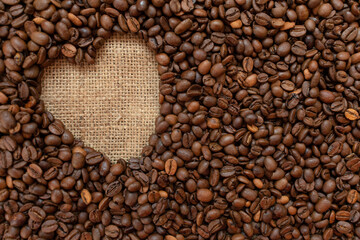 Background from coffee beans and heart.Copy space.