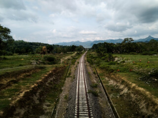 Fototapeta na wymiar Blur view of railroad tracks in the countryside for background