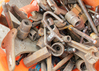 metal waste bin, container full of various iron waste, rusty old antique iron tools
