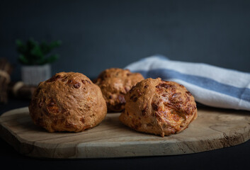 Flax flour crunchy bagels, home baked, wooden board, cloth, selective focus, dark background, natural light.