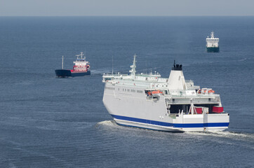 Fototapeta premium MARITIME TRANSPORT - Passenger ferry and freighters go at sea