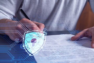 A businessman in casual wear signing the contract to prevent probability of risks in cyber...