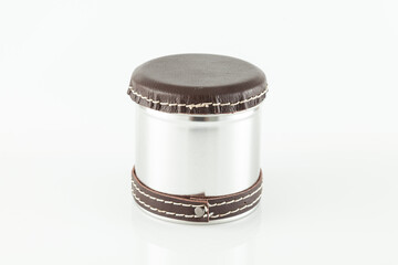 Multipurpose metal container decorated with leather; photo on white background.