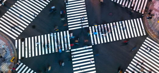 Traffic and people cross a busy intersection in Ginza