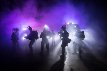 Anti-riot police give signal to be ready. Government power concept. Police in action. Smoke on a dark background with lights. Blue red flashing sirens. Dictatorship power - obrazy, fototapety, plakaty