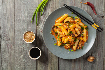 Traditional Korean Tteokbokki rice noodles with chicken, vegetables and shitake mushrooms. Prepared in a pan.