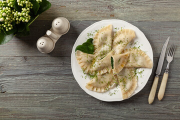Dumplings with spinach, topped with melted butter and sprinkled with chopped dill