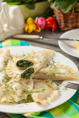 Dumplings with spinach, topped with melted butter and sprinkled with chopped dill